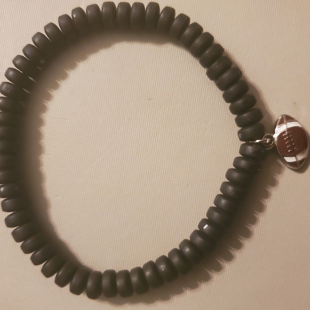 Handmade by my daughter. Black Beaded Bracelet with Silver football Charm.